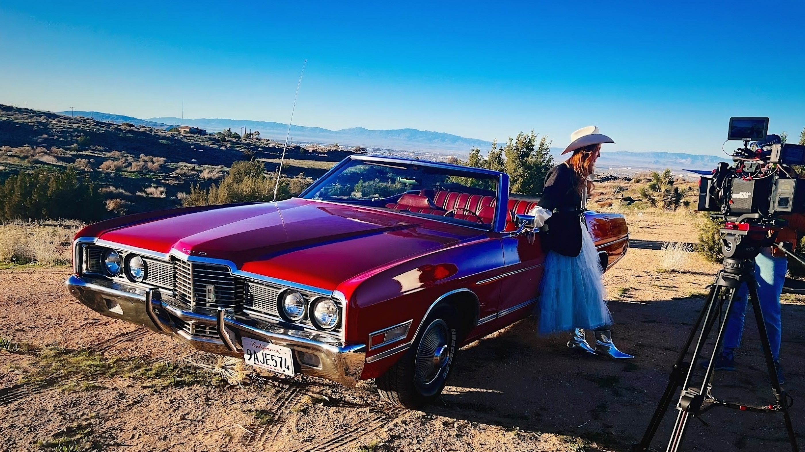 Friends enjoying a scenic driving experience along the coast in a classic rental car